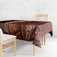 Red tablecloth draped over dining table with Polynesian tribal print