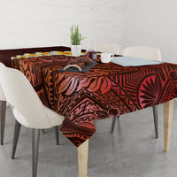 Red tablecloth with plumeria and Polynesian tribal motifs across dining table