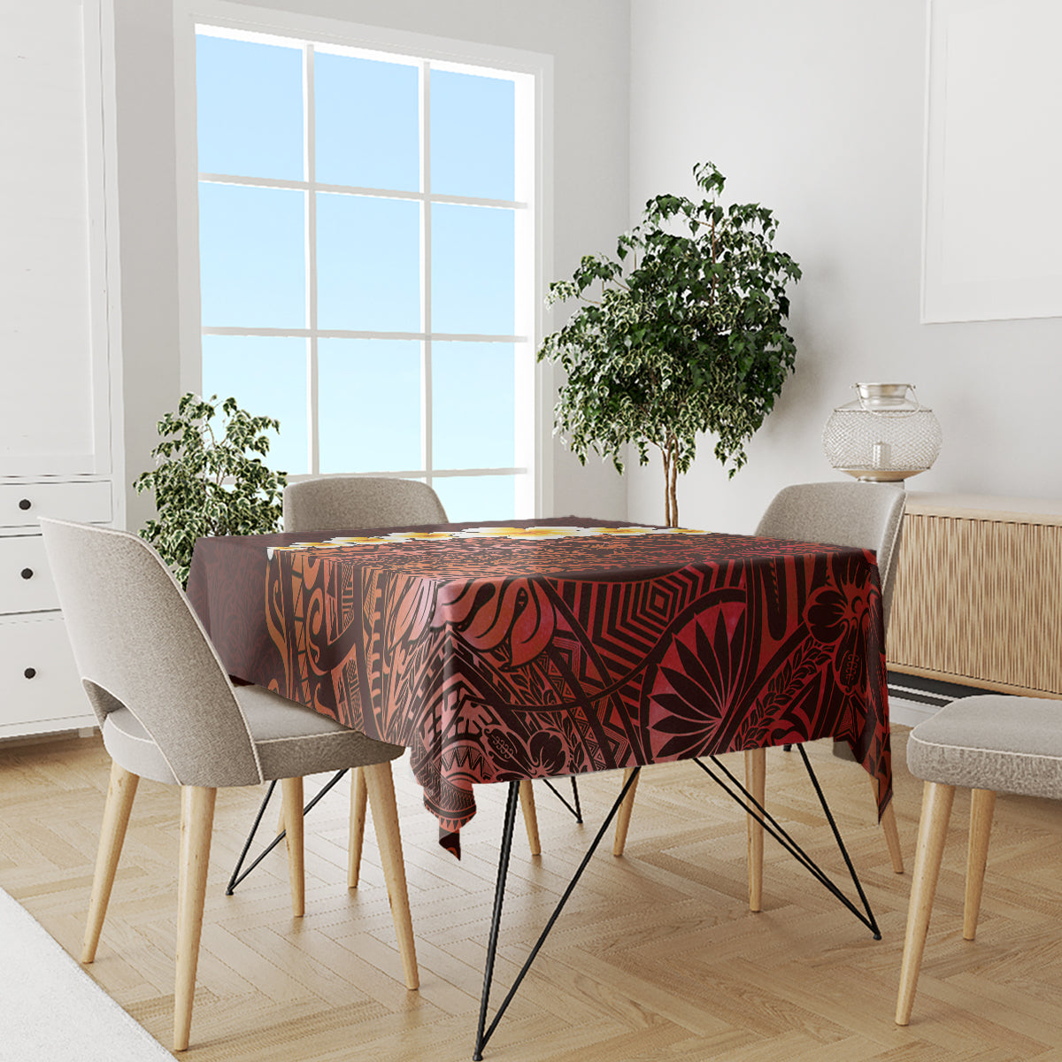 Red tablecloth with Polynesian floral-and-tribal design on dining table