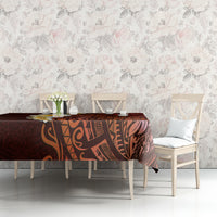 Red tablecloth with Polynesian tribal design on table with dining chairs