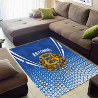 Blue Estonia football area rug in living room with crest and graphic text pattern