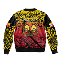 Black bomber jacket with Polynesian tiki face graphic and yellow red patterned sleeves