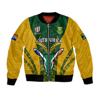 Green and yellow bomber jacket with full zipper, ribbed cuffs, kente-style South Africa print