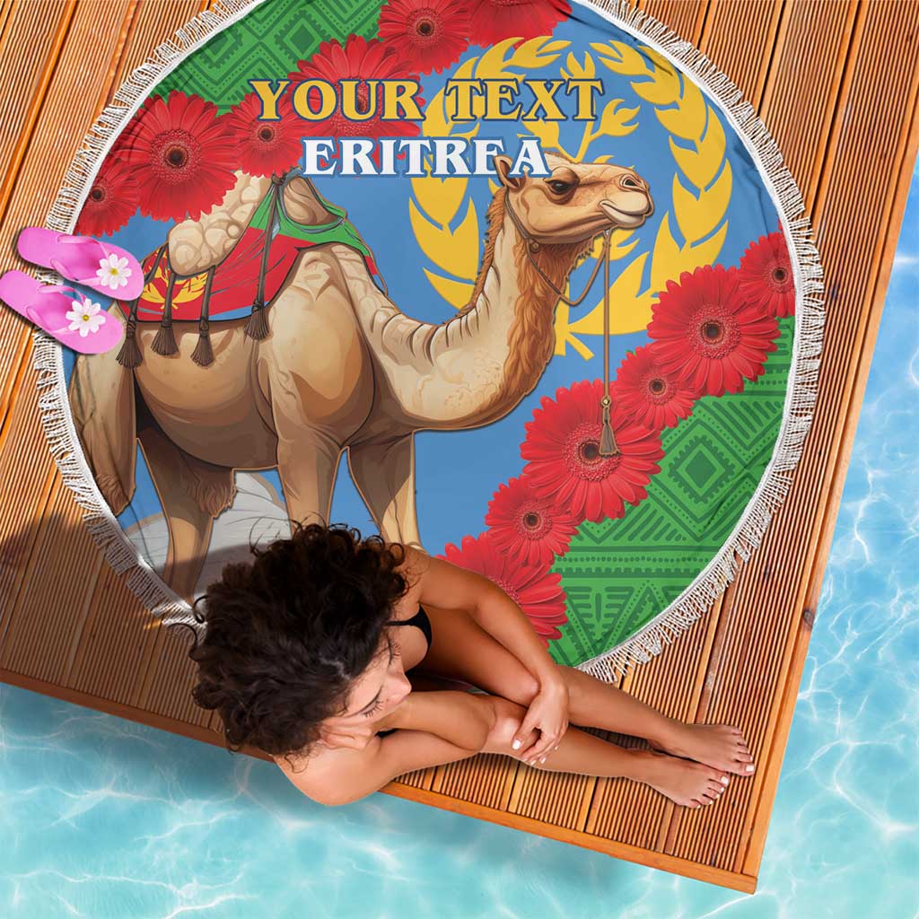 Round beach blanket, Eritrea text over camel artwork with red gerbera flowers and fringe