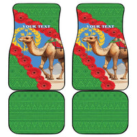 Set of four green car mats with camel, laurel, and red flower pattern and geometric trim