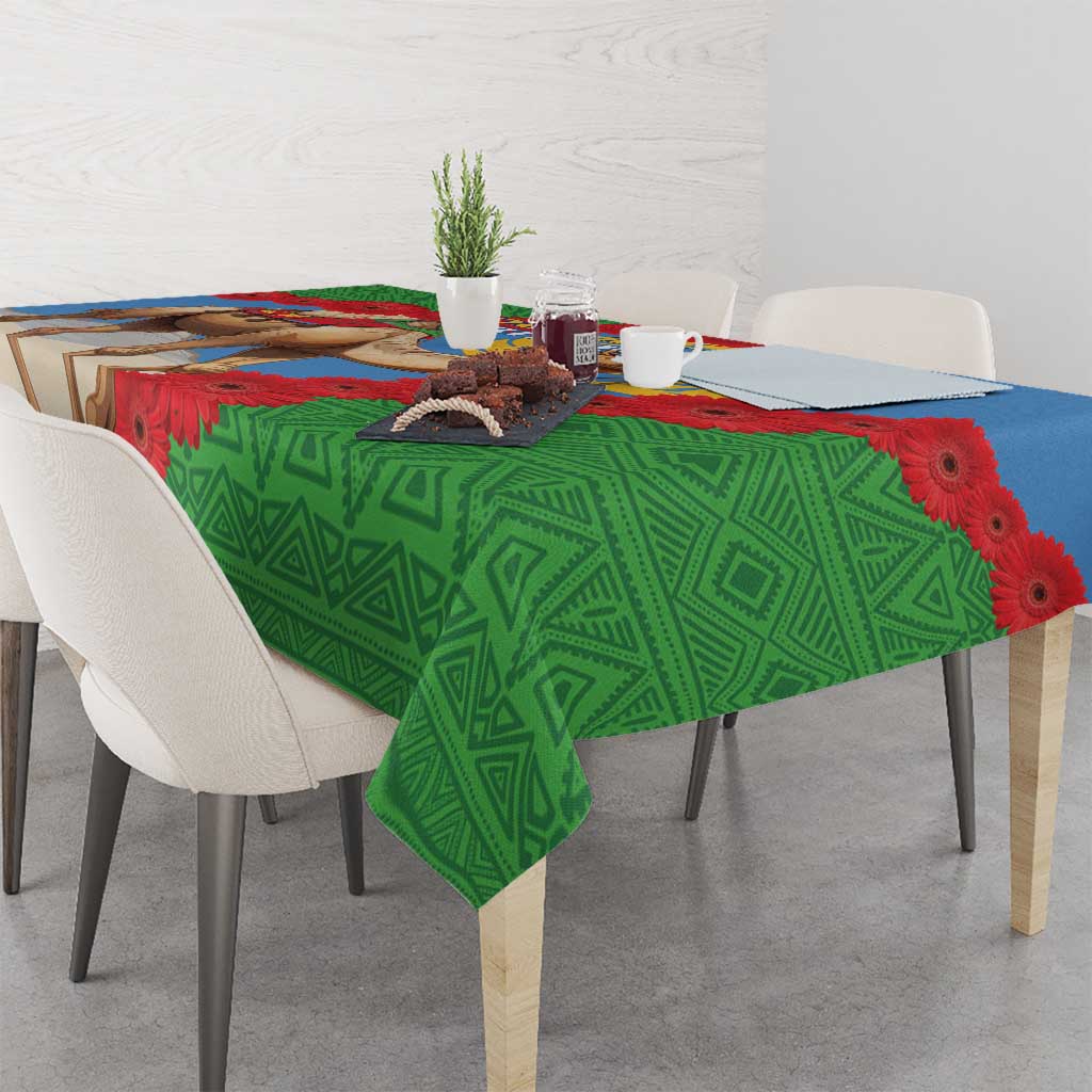 Green Eritrea tablecloth with camel, blue band, red gerbera flowers and geometric patterns