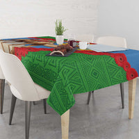 Green Eritrea tablecloth with camel, blue band, red gerbera flowers and geometric patterns