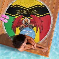 Round fringed Mali beach blanket with coat of arms, 'YOUR TEXT', and black-and-yellow chevrons
