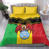 Mali bedding set with two yellow patterned pillowcases and multicolor duvet, 'YOUR TEXT' coat of arms