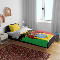 Mali bedding set on bed: multicolor duvet with black chevrons and coat of arms image