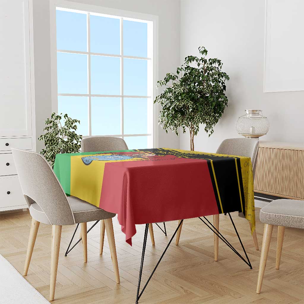 Personalised Mali tablecloth draped over dining table, yellow/green/red coat-of-arms vulture
