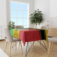 Personalised Mali tablecloth draped over dining table, yellow/green/red coat-of-arms vulture