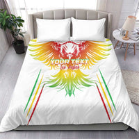White duvet cover and pillow set with bold eagle wing artwork in red, yellow, and green