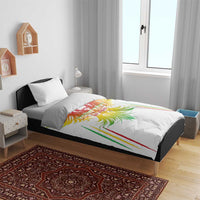 White bedding set on bed with colorful eagle wing graphic on duvet and matching pillow