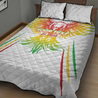 White quilt with red, green, and gold eagle print and two matching pillows