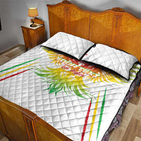 White quilt bed set with centered eagle graphic and two square pillows