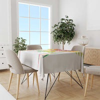 White football tablecloth draped over rectangular dining table with colorful crest at center