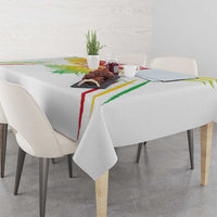 White football tablecloth on dining table with colorful crest and red-green trim