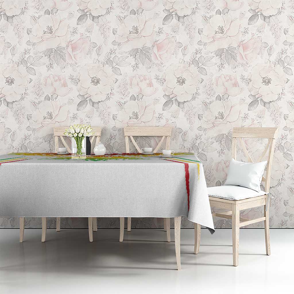 White football tablecloth with colorful crest and red-green stripe border on dining table