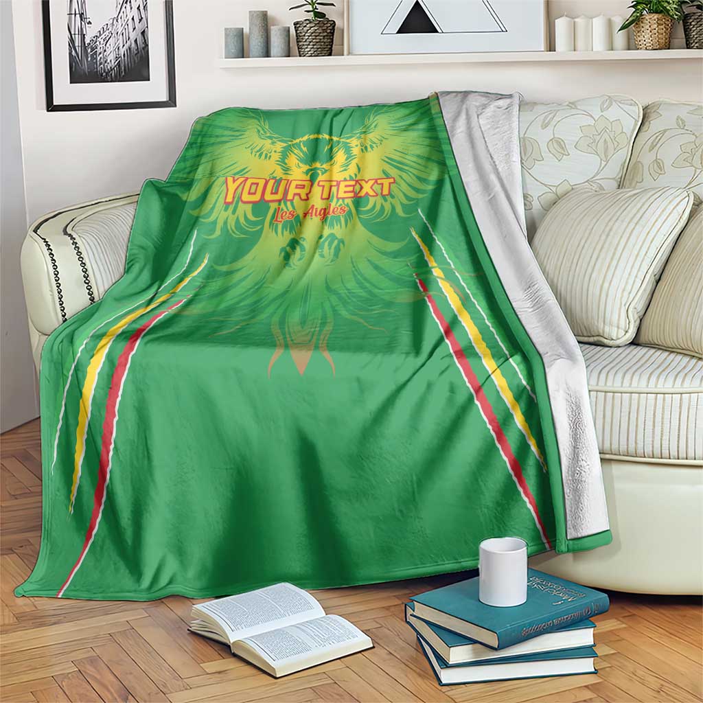 Green football blanket with eagle wings and 'YOUR TEXT' print, draped on couch arm