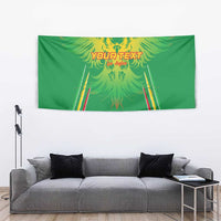 Green football tapestry with yellow eagle artwork and red-yellow striped goal posts