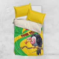 Folded bedding set with yellow duvet and green Mali map, featuring vulture artwork, with two pillows