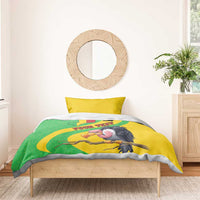 Bedding set on a bed with yellow duvet showing Mali map and vulture graphic, and two pillows