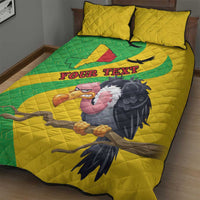 Yellow quilt bed set with green oval map panel and bird artwork, two pillows on bed.