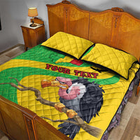 Yellow quilt bed set with green map band, bird graphic, and two square pillows with black trim.