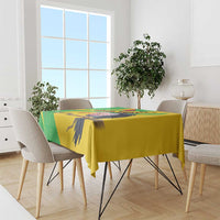 Yellow Mali vulture tablecloth with green map-style border on dining table.