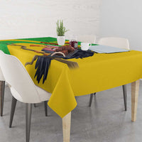Yellow Mali vulture tablecloth with black bird wing graphic and green geometric panel.