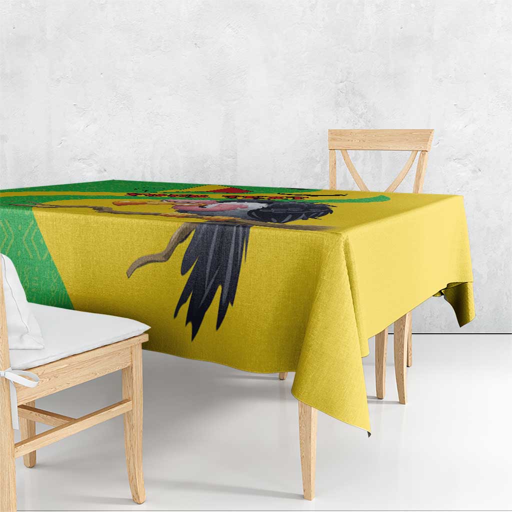 Yellow Mali vulture tablecloth with black vulture wing motif and green geometric stripe.