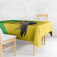 Yellow Mali vulture tablecloth with black vulture wing motif and green geometric stripe.