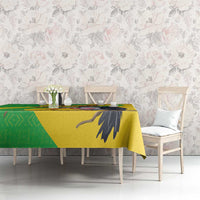 Yellow Mali vulture tablecloth with green geometric section and black bird wing motif.