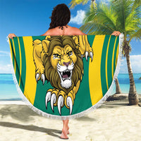 Round lion-themed beach blanket: green center, yellow stripes, fringed border, crest.