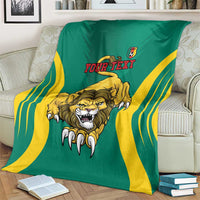 Green football blanket with lion emblem, yellow stripes, and Your Text shown on sofa
