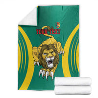 Green football blanket with yellow stripes, roaring lion design, and Your Text (folded)