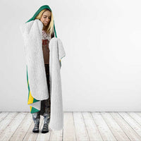 Green hooded blanket with white sherpa front and yellow striped edge, full-body drape