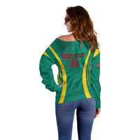 Green off-shoulder sweater, back view: yellow stripes with “YOUR TEXT 15” print.
