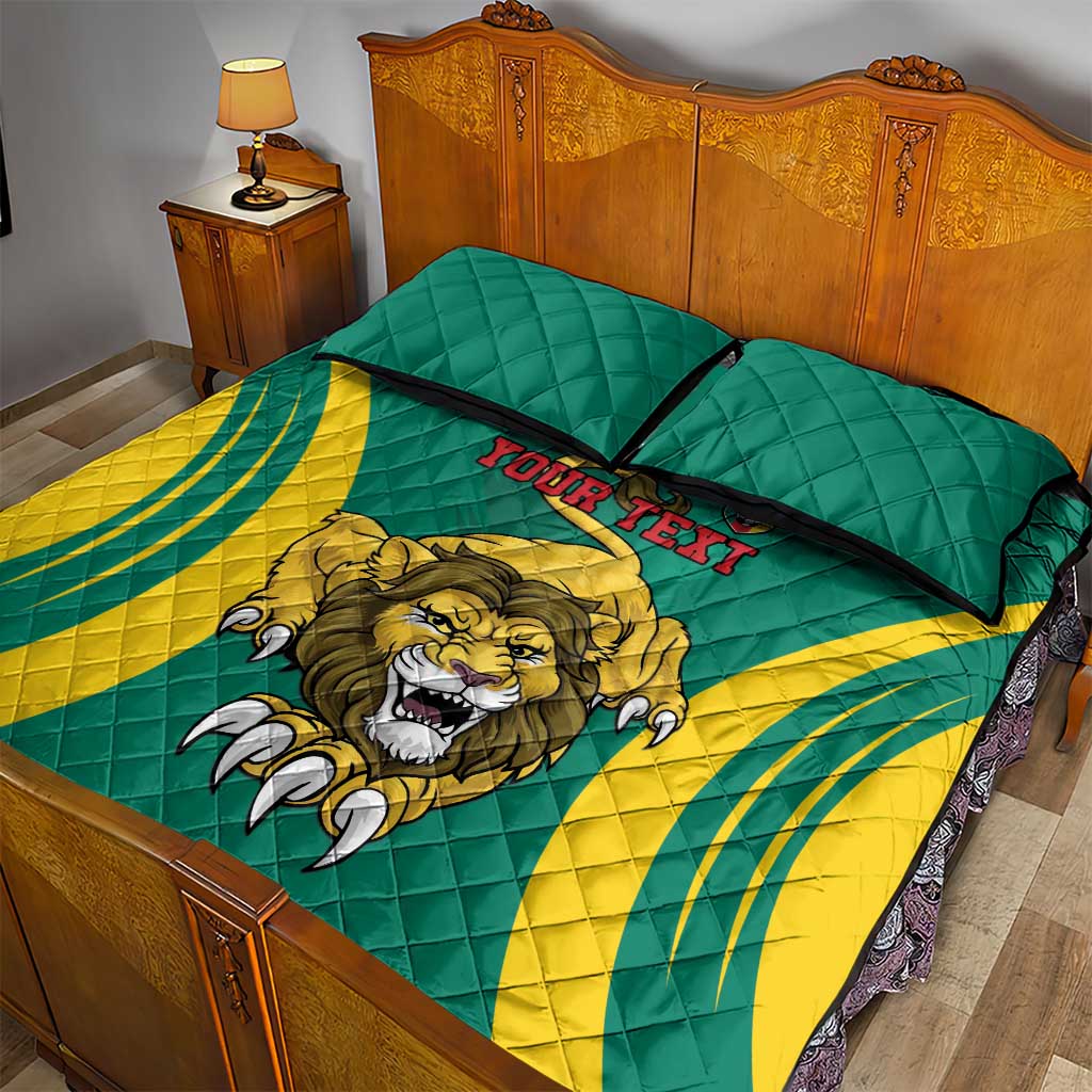 Green quilt with lion graphic and black piping, shown with two pillowcases