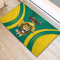 Green rubber doormat corner view with lion graphic, yellow curved stripes, and 'YOUR TEXT'