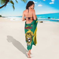 Green lion emblem sarong with yellow curved stripes and red "YOUR TEXT" text on back