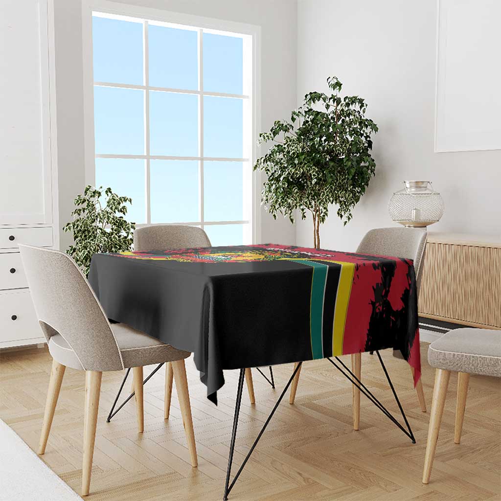 Mozambique Revolution Day tablecloth draped on dining table, black with red and green stripe.