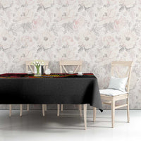 Mozambique Revolution Day tablecloth on dining table, black fabric with colorful border stripe.