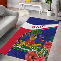Haiti area rug laid in living room, blue pattern with 'HAITI' stripe and floral border