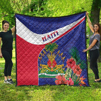 Haiti quilt with blue top, red bottom, white diagonal stripe, and floral coat-of-arms design