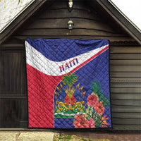 Haiti quilt square hanging outdoors with blue top, red bottom, and hibiscus-themed crest