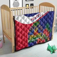 Haiti quilt on a wooden toddler bed frame with blue, white, and red hibiscus artwork