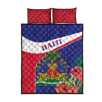 Quilt bed set with red pillowcases and blue quilt panel featuring “HAITI” lettering and emblem art