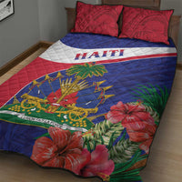 Quilt bed set with blue and red quilt, white diagonal stripe, “HAITI” text, and hibiscus flowers